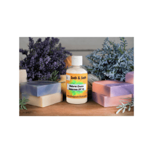 Natures Choice Sunscreen SPF 45 8.0 oz bottle surrounded by lavender flowers and colorful soap bars, promoting natural skincare products from The Goats Field.