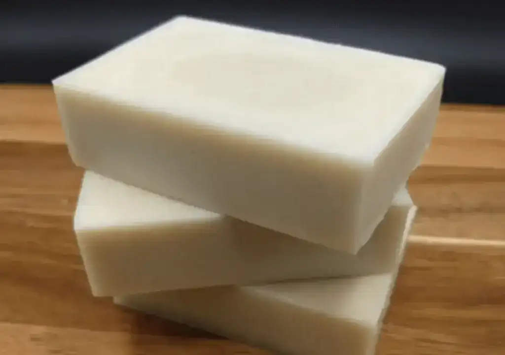 A stack of handmade goat milk soap bars, perfect for nourishing hair and skin.